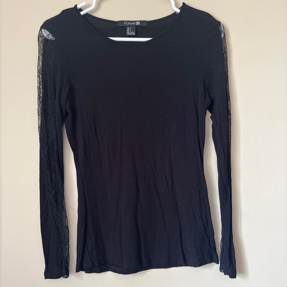 Forever 21 black long sleeve shirt with lace strips on the outside of the arms